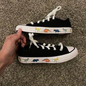 Converse Chuck Taylor black kid shoes with dinosaur footprints